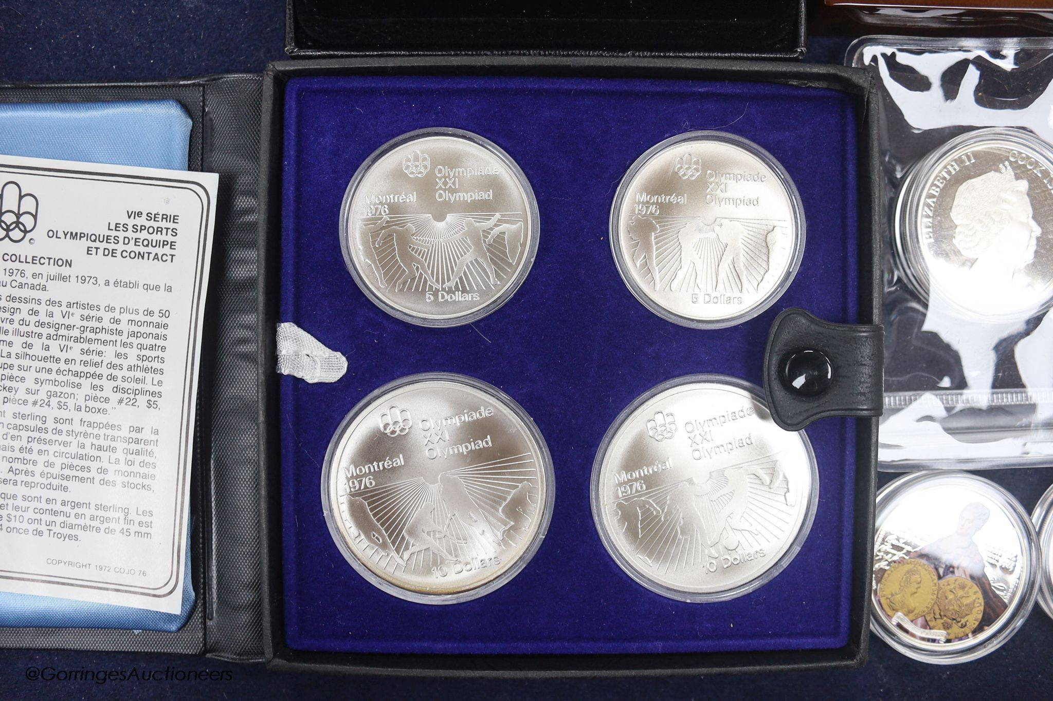 A group of silver proof coins, to include a JVP boxed orthodox shines $2, a Masterpieces of Art Cook Islands $20, a set of 1976 Montréal Olympics coins, a Cook Islands $5, three half ounce silver proof coins, a Niue Isla